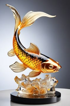 a gold fish statue sitting on top of a table