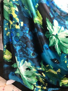 "\"Floral Fusion\": Blue, green, and yellow printed silk charmeuse. (302) Sold by the yard ($41). 16mm 45 inch width. Dry cleaning recommended. 100% silk." Green Silk Scarf For Party, Patterned Printed Silk Scarf, Thread Spools, Yellow Print, Silk Charmeuse, Silk Organza, Printed Silk, Green And Yellow, Gorgeous Fabrics