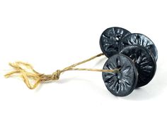 three black buttons tied together with twine