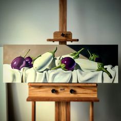 an oil painting of radishes on a canvas in front of a wooden easel