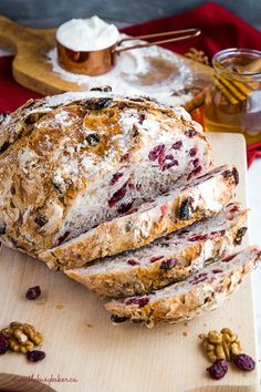 a loaf of cranberry bread on a cutting board