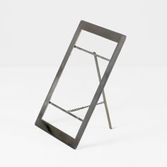 a metal frame with a chain hanging from it's side on a white background