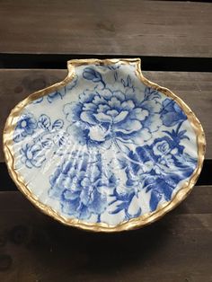 a blue and white plate sitting on top of a wooden table next to a wall