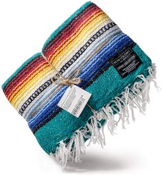 the multicolored blanket has fringes on it and is tied up with a tag