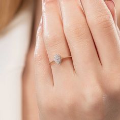 a woman's hand with a diamond ring on it