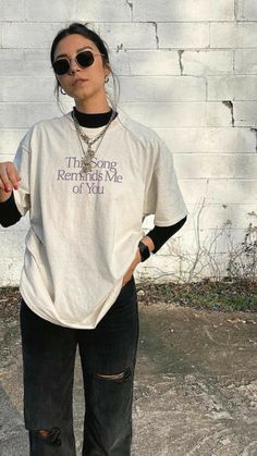 a woman in black jeans and a white shirt