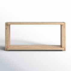 a wooden shelf sitting on top of a white wall