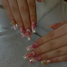 two hands with pink and white flowers on them