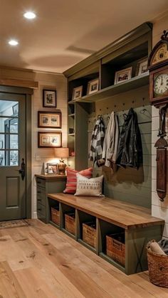 an entryway with a bench, coat rack and clock