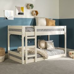 a white bunk bed sitting next to a blue wall