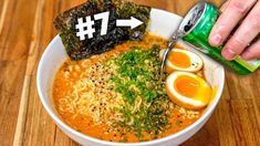 someone is dipping an egg into a bowl of ramen