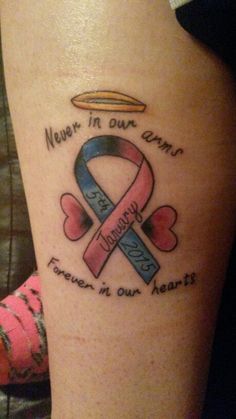 a woman with a tattoo on her leg that says never in our arms forever in our hearts