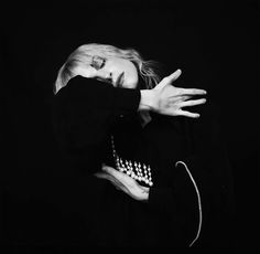 a black and white photo of a woman covering her face