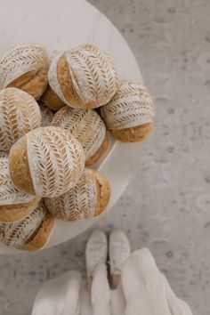 a white plate topped with lots of pastries on top of a marble countertop