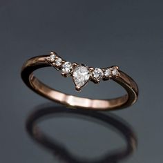 a gold ring with three diamonds on it