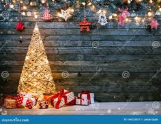 christmas tree and presents on wooden background with lights