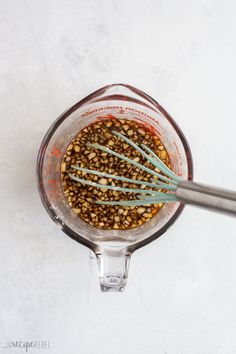 an overhead view of a blender filled with food and whisk in it