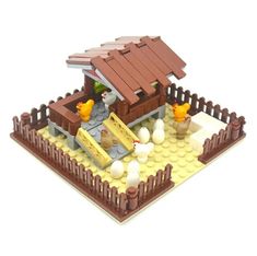 a lego model of a small house made out of wood and plastic bricks, with an attached roof