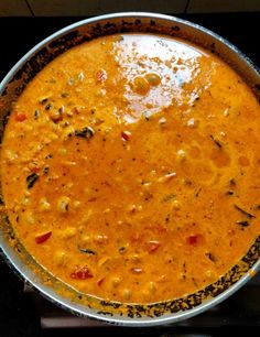 a pan filled with soup sitting on top of a stove