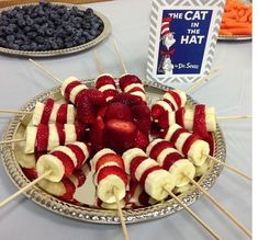 strawberries, bananas and blueberries are arranged on skewers to look like the cat in the hat