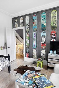 a living room filled with lots of skateboards mounted to the side of a wall