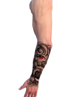 a man's arm with a tattoo on it and red eye in the middle