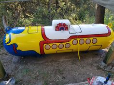 a large yellow submarine shaped water tank sitting on the ground