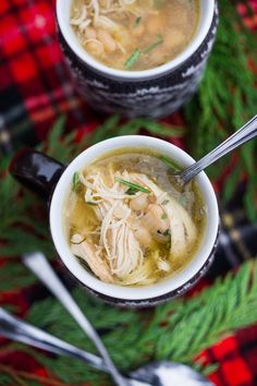 two bowls of chicken noodle soup on a table