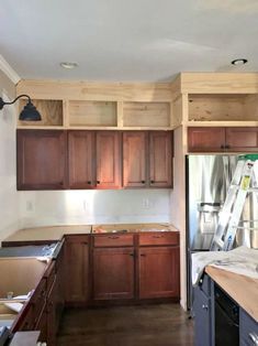 an empty kitchen with wooden cabinets and counter tops in the process of remodeling