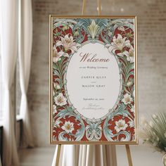 a welcome sign with flowers on it in front of a brick wall and vases