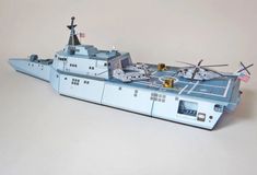 a toy model of a navy ship with helicopter on top