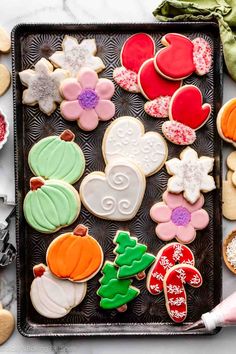 an assortment of decorated cookies on a tray