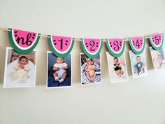 some pictures hanging from a clothes line with watermelon and numbers attached to them