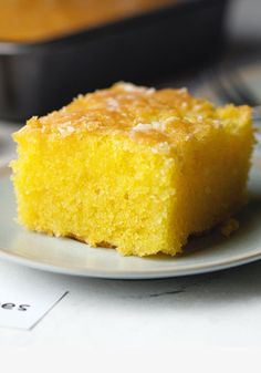 a piece of cake sitting on top of a white plate next to a baking pan