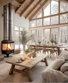 a living room filled with furniture and a fire place in front of a large window