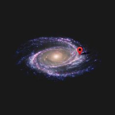 a spiral galaxy with a red pinhole in the center