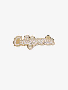 the word california in gold with white lettering on a white background, it is made from metal