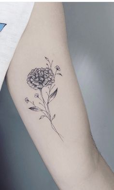 a black and white flower tattoo on the arm