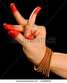 a woman's hand with red nail polish holding up the peace sign