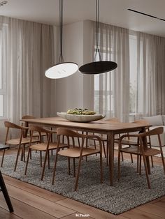 a dining room table with chairs and a bowl of fruit on it