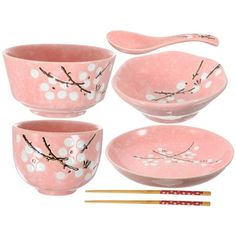 four pink bowls with spoons and chopsticks