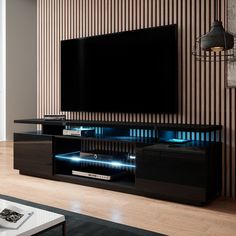 a living room with a large television on top of a wooden entertainment center in front of a wall mounted flat screen tv