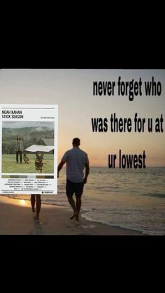 two men walking on the beach with an advertisement behind them that reads never forget who was there for u at ur lowest