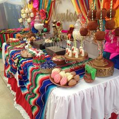 a table topped with lots of desserts and candy