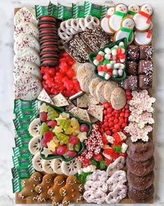 a platter filled with lots of different types of cookies and candys on top of a table