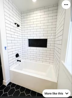 a white bath tub sitting inside of a bathroom next to a shower head faucet