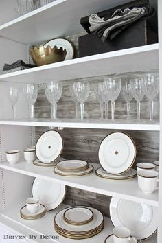 the shelves are filled with dishes and glasses for dinner or party guests to enjoy themselves