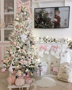 a white christmas tree with pink and silver ornaments