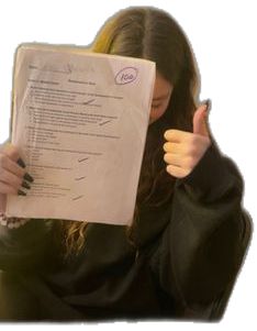 a woman holding a piece of paper with writing on it