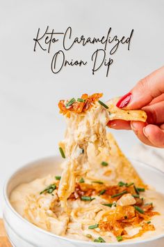 a person dipping some kind of food into a bowl with the words keto caramelized onion dip